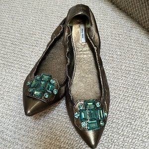 Miu Miu bronze leather flats with green jeweled toes.